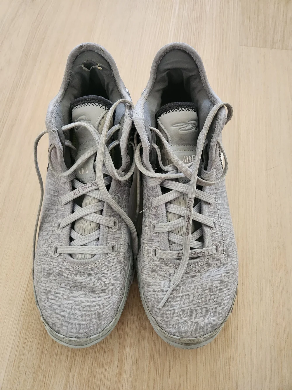 Nike Gray and White Low-Top Sneakers with Gold Swoosh